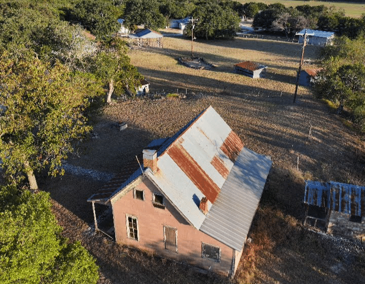 A rustic, weathered house in the countryside highlights differences in the cottage vs house debate