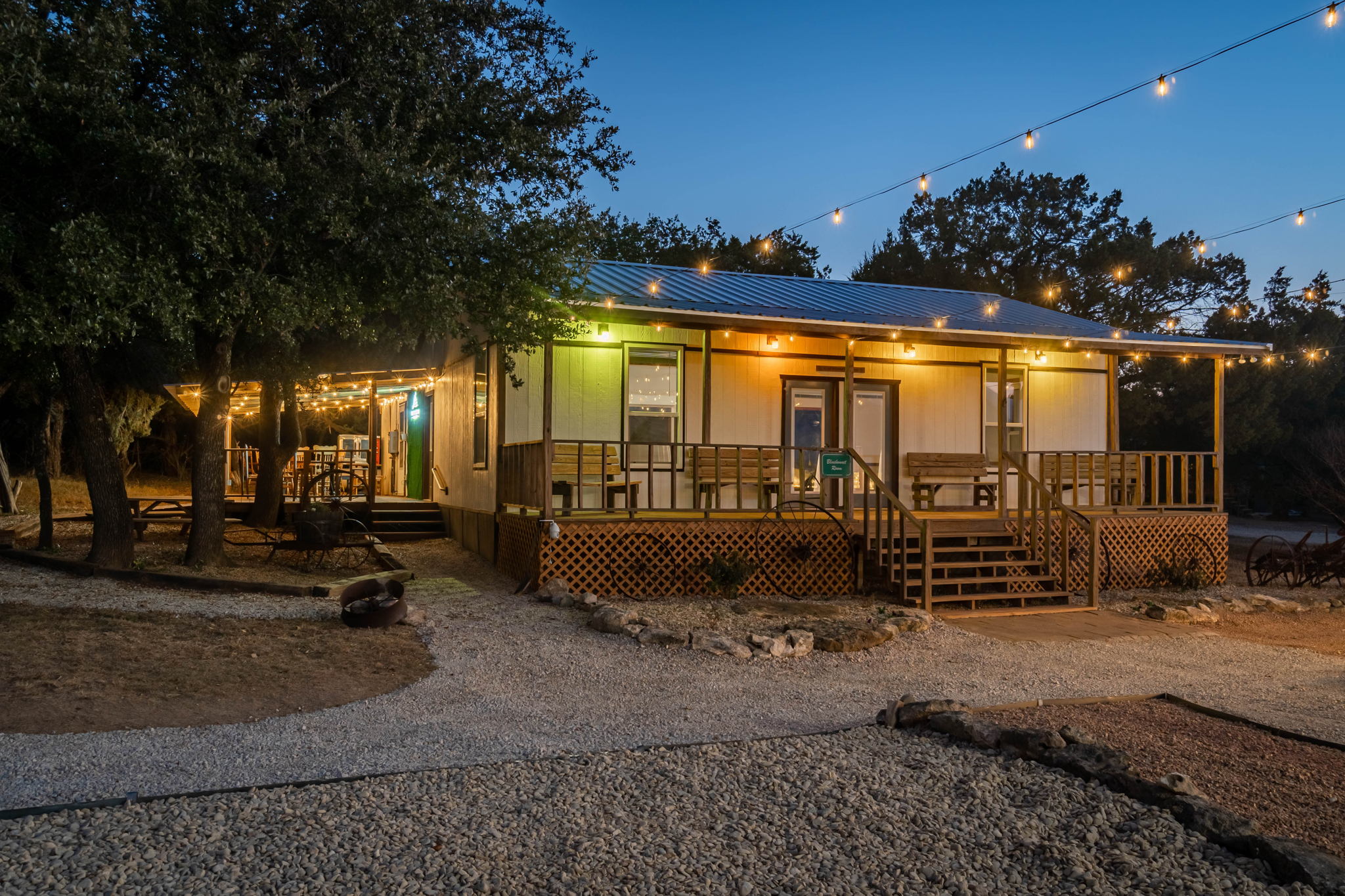 String lights illuminate a rustic building—highlighting what to look for in a wedding venue