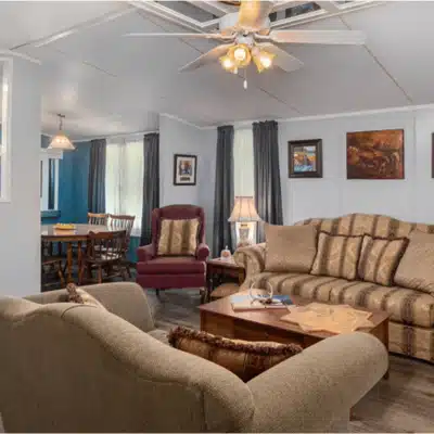 Comfortable groom lounge with sofas, chairs, and decor, designed for relaxing before the wedding