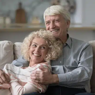 Elderly couple cuddling, reminding us what is the purpose of a honeymoon for lasting connection