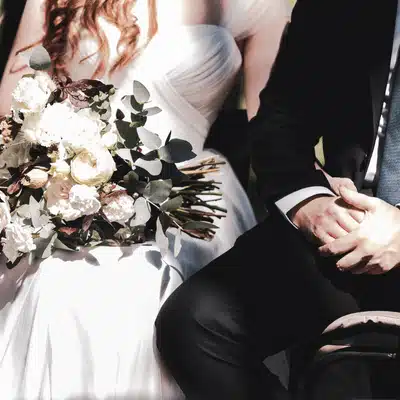 Bride holds bouquet beside groom, elegant attire captured at romantic tuscan texas outdoor wedding ceremony